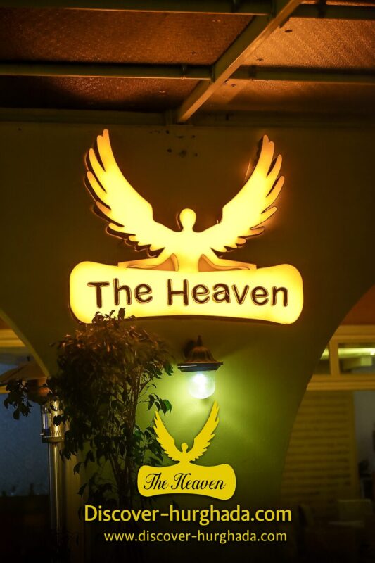 The Heaven Restaurant Hurghada illuminated logo sign at night with Discover Hurghada branding