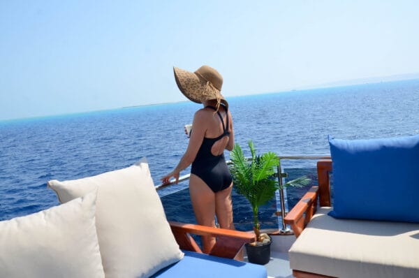 Woman on a boat near Orange Bay Hurghada holding a drink